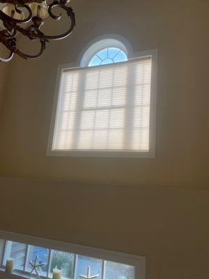 Do you have a window high above your entrance that you need to control the sun in? A motorized cellular shade is just the thing!