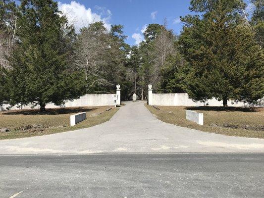 The community is surrounded by a stucco wall centered on two grandiose entrances.