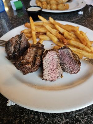 Beef tenderloin medallions, ordered medium, and fries