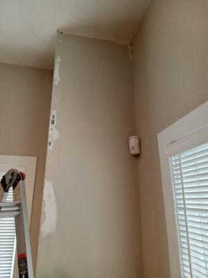 Before repair of corner wall drywall.