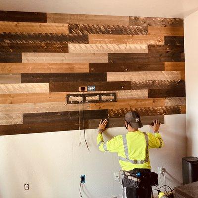 Laying wood planks on wall