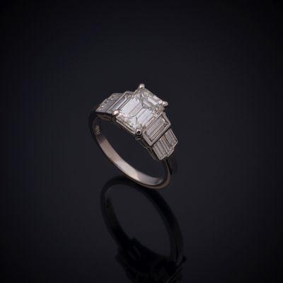 Custom made Platinum Art Deco engagement ring with 1.50 Carat Emerald Cut GIA Certified Natural Diamond and Diamond Baguette accents.