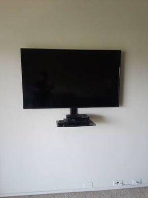 TV Mounted w/ tilt mount and hidden wires.