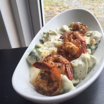 Grilled shrimp over a creamy spinach tortellini