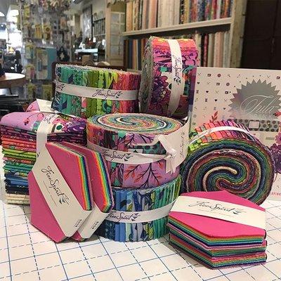 Specialty quilting fabrics available in fat quarters, jelly rolls, and hexi packs!