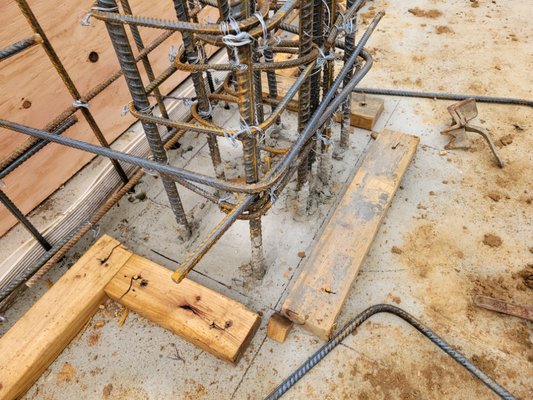 Buldding wood forms and installing rebar for stem walls to build concrete elevator shaft