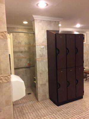 Men's bathroom area with shower and more lockers