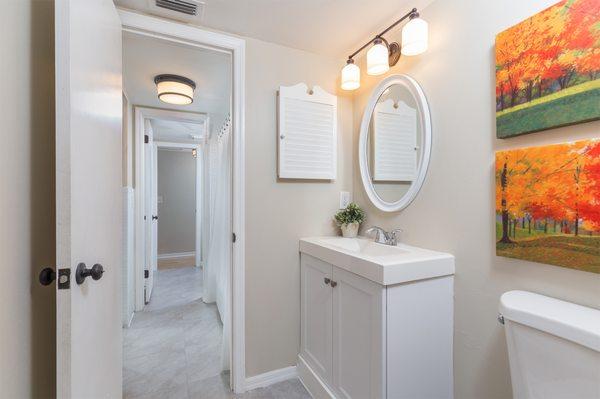 Updated jack and jill bathroom with new vanities, flooring and paint