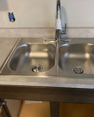 Kitchen remodeling, installed stainless steel bowl and installed kitchen facet.