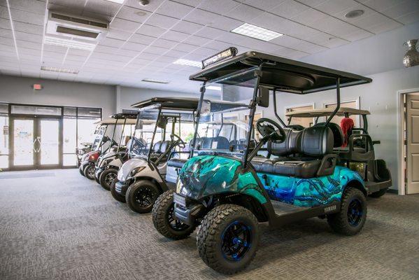 Some golf carts inside The Avenue Viera showroom.