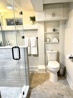 Basement bathroom with clever cover of plumbing stack