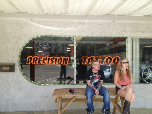 Out front of precision tattoo