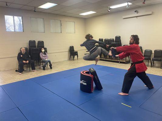 Jumping side kick! Showing off those blackbelt skills