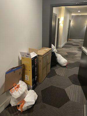 Trash lining the hallway leading to my apartment door