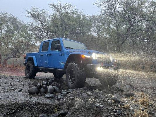 Our 2021 Lifted Jeep Gladiator off roading during a rain storm in Maui.