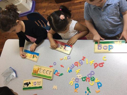 3's exploring letters and words.