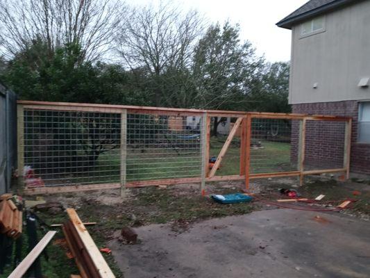 Wool panel fence 4by4 post 2by4 trim with 2by 6 top..