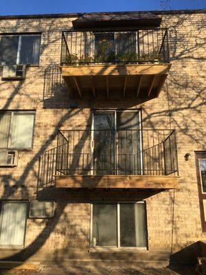 Balconies wood  decking iron railing.