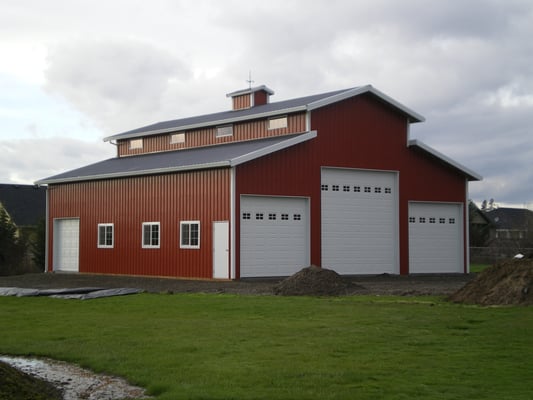 Custom pole building shop. Monitor style barn with overhead doors and roof cupola for added beauty and ventilation.