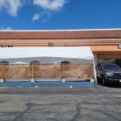 Outdoor, covered seating blocking the name on the building