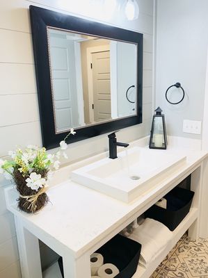 Put shiplap on the wall, built a new vanity with new luxury quartz with a trough sink.