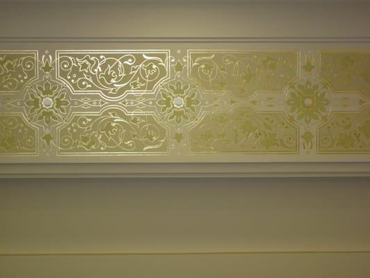 A stenciled frieze designed, drawn, & installed by Iconography Finishing. Design consists of 23K gold leaf, pearl& flat paint.