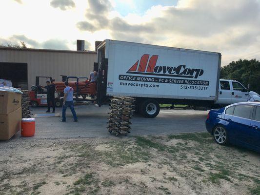 Our movers carefully loading heavy equipment.