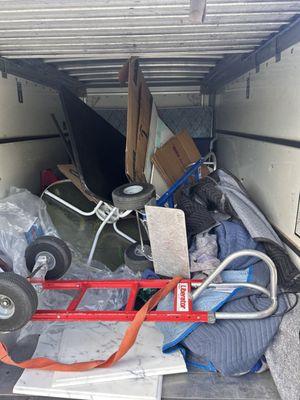 Junk hauled away thrown into box truck.