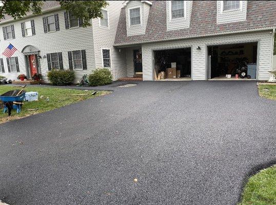 Rip out and installation of new paving & and oval opening for a flower bed.