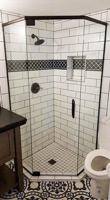 We never miss a detail! This unique bathroom features beautifully designed flooring, and a walk-in shower