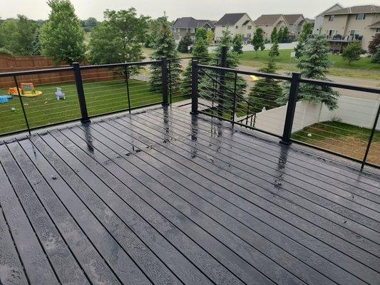 Awesome looking deck with cable railing and a spiral staircase