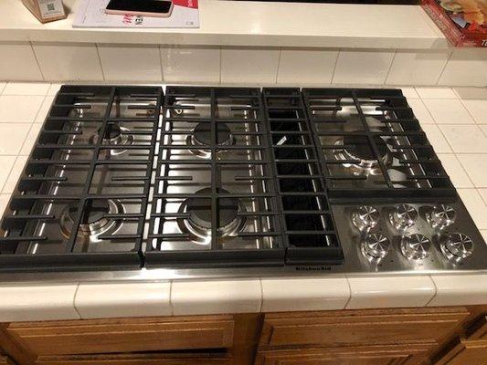 Brand new cooktop with the micro trim in the back to cover up the gap. Danny did such a great job