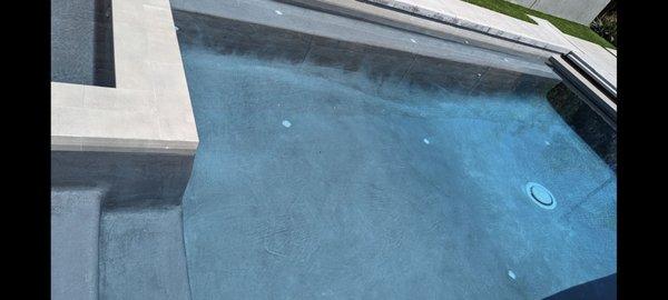 Brand new pool with black patches all over the sides and bottom. Ruined concrete sides due to chemical imbalance