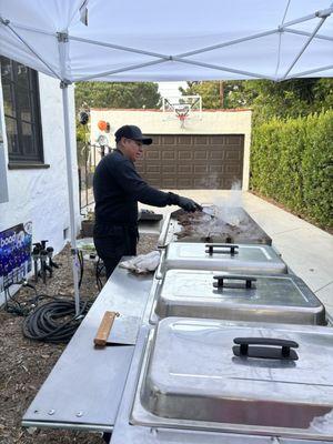 Food serving area, meal prep area, cooking meat in grill.