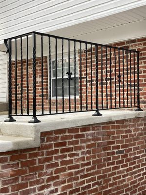 Simple yet elegant out door iron railing with a butterfly center in each panel. Includes alternating twisted balusters.