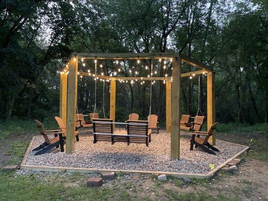 Outdoor area with chairs, swings and fire pit