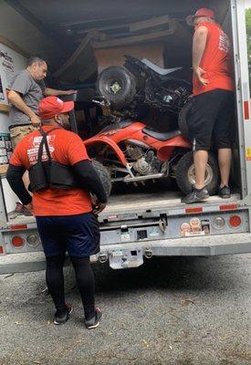 This is how they actually load your things, notice the unwrapped desk behind the stacked ATV's