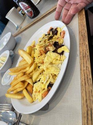 Omelette with burnt onions and fries.