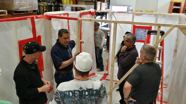 Expert instructor Dan Beaver instructs an asbestos abatement class on containment construction.