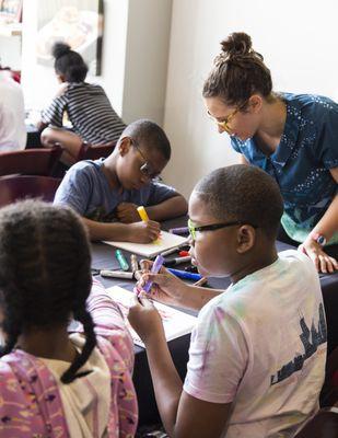 An Ink Factory artist supervises young visual note-takers during a Think Like Ink workshop.