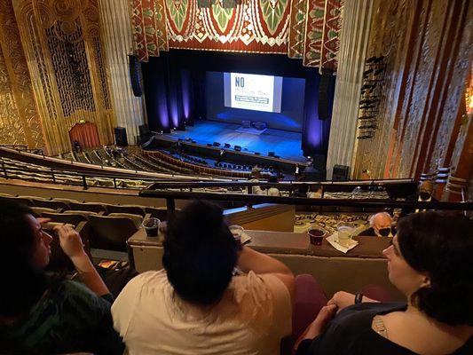 Balcony middle. They got in trouble for putting drinks on the railing. No phones during the show but before and after are OK.