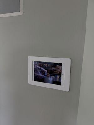 Master bedroom in wall iPad Savant control unit and in-wall NHT speakers