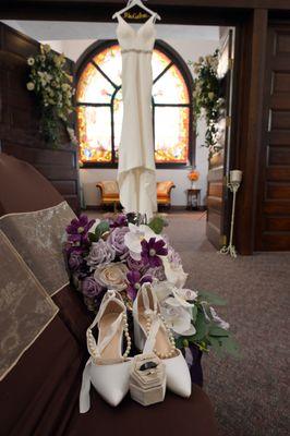 Detail photo of the bride's shoes, jewelry and dress.  This view looks from the chapel area to the Bridal Suite where the brides get dressed