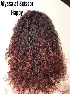 Gorgeous red ombre for naturally curly hair by Alyssa. Every stylist here are trained to work with all curly hair types.