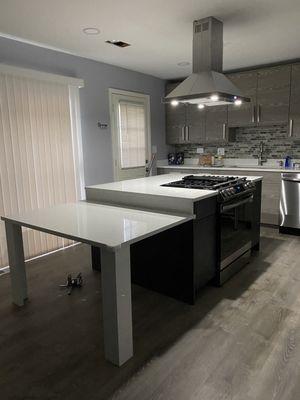 Cabinets, range hood, floor, and appliances installed by Orozco construction