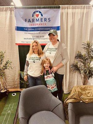 Employees and family working at the 2023 Lansing Home & Garden Show