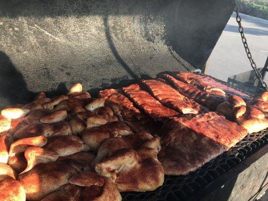 Chicken halves and ribs on the grill yummy