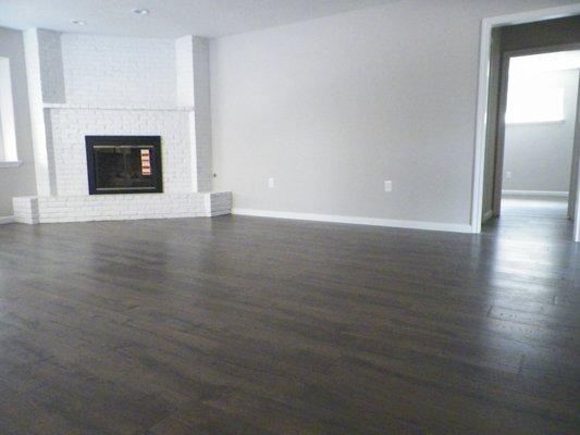 Remodeled living room with brick fireplace.