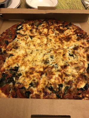 Spinach and sausage pizza