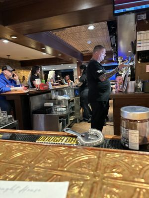 The main bar with the staff bring busy.